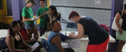 Volunteers helping to check the blood of locals in Belize Projects Abroad volunteers checking blood as part of her Spring Break Public Health Project in Belize